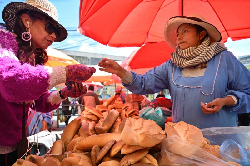 A vendor sells bread as shortages of Bolivia's state-subsidized marraqueta bread roll create an early test for newly elected President Rodrigo Paz, with dwindling wheat supplies and rising costs squeezing bakers and frustrating consumers, in La Paz, Bolivia November 27, 2025. REUTERS/Claudia Morales