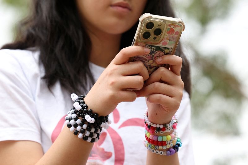 Annie Wang, 14, poses after an interview discussing Australia’s social media ban for users under 16, which is scheduled to take effect on December 10, in Sydney, Australia, November 22, 2025. REUTERS/Hollie Adams