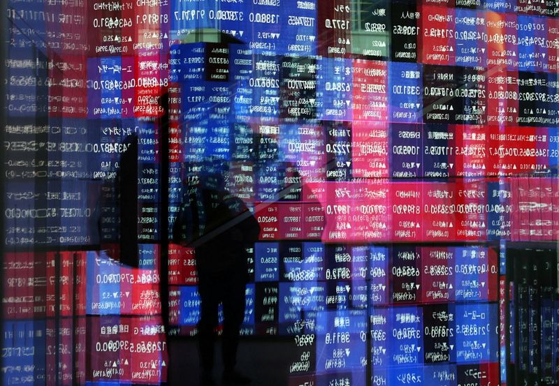 A stock quotation board is reflected on window glasses at a building in Tokyo, Japan December 11, 2025.  REUTERS/Issei Kato