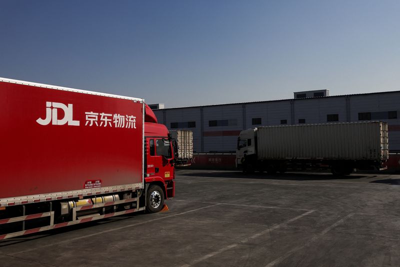 Trucks are parked next to the buildings of JD.com sorting center in Beijing, China, November 11, 2025. REUTERS/Maxim Shemetov