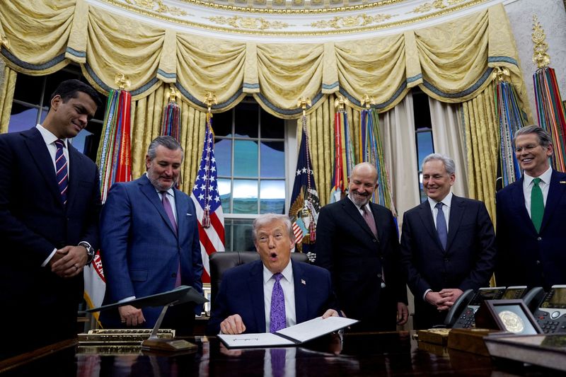 FILE PHOTO: U.S. President Donald Trump holds a signed executive order on AI next to Sriram Krishnan, Senior White House Policy Advisor on Artificial Intelligence, U.S. Senate Commerce Committee Chairman Ted Cruz (R-TX), U.S. Commerce Secretary Howard Lutnick, David O. Sacks, Chair of the President's Council of Advisors on Science and Technology, and U.S. Treasury Secretary Scott Bessent, in the Oval Office at the White House in Washington, D.C., U.S. December 11, 2025. REUTERS/Al Drago/File Photo