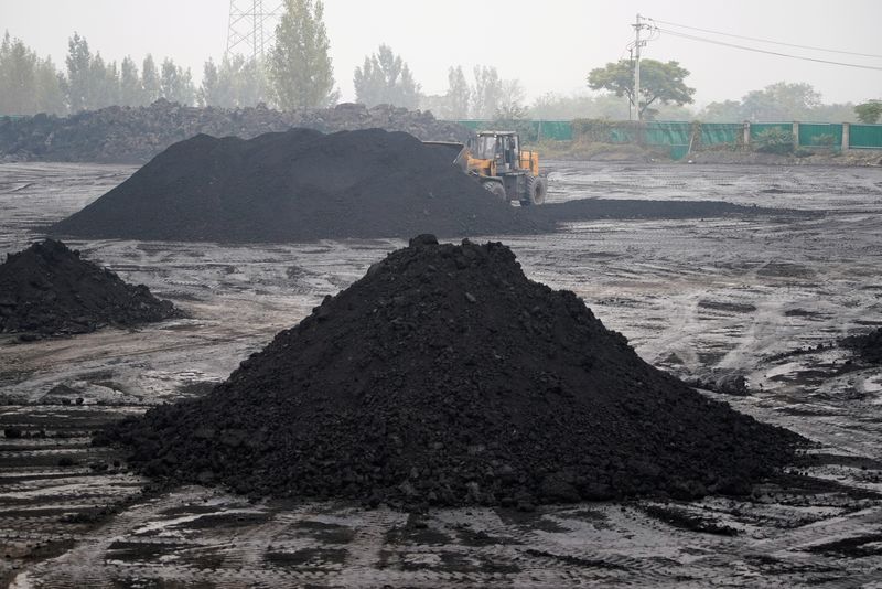 An excavator sift through dunes of low-grade coal near a coal mine in Pingdingshan, Henan province, China November 5, 2021.  REUTERS/Aly Song