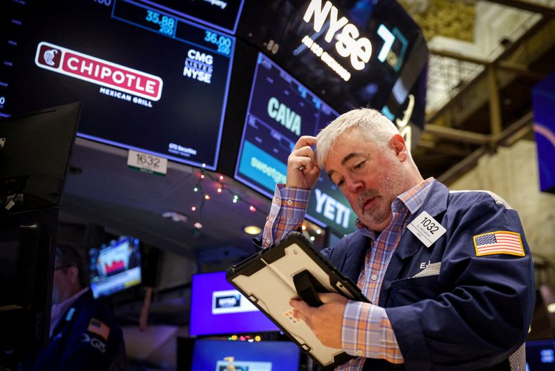 FILE PHOTO: A trader works on the floor at the New York Stock Exchange (NYSE) in New York City, U.S., December 15, 2025.  REUTERS/Brendan McDermid/File Photo