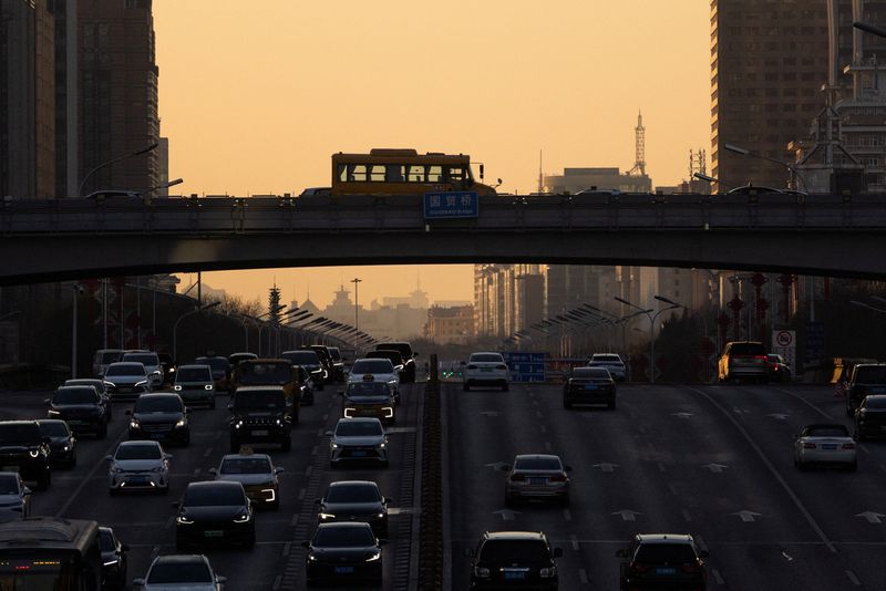 Cars drive along the road during sunset in Beijing, China, January 5, 2026. REUTERS/Maxim Shemetov