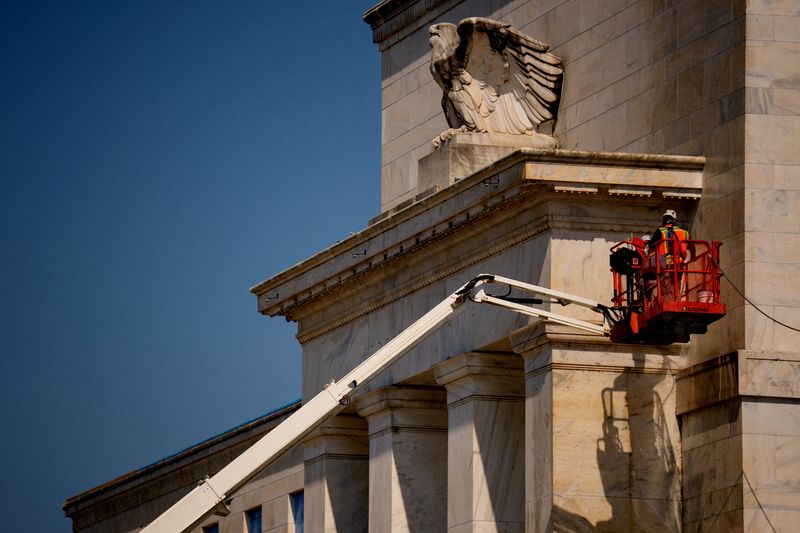 FILE PHOTO: A view shows the front facade of the Marriner S. Eccles Federal Reserve Board Building as a massive renovation continues on the building and the 1951 Constitution Avenue Building, in Washington, D.C., U.S., July 24, 2025.  Andrew Harnik/Pool via REUTERS/File Photo