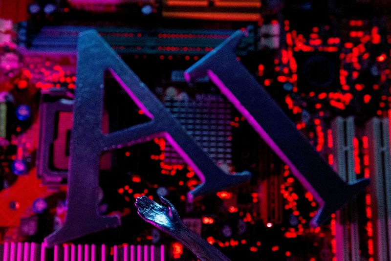 FILE PHOTO: AI (Artificial Intelligence) letters and robot hand are placed on computer motherboard in this illustration created on June 23, 2023. REUTERS/Dado Ruvic/Illustration//File Photo