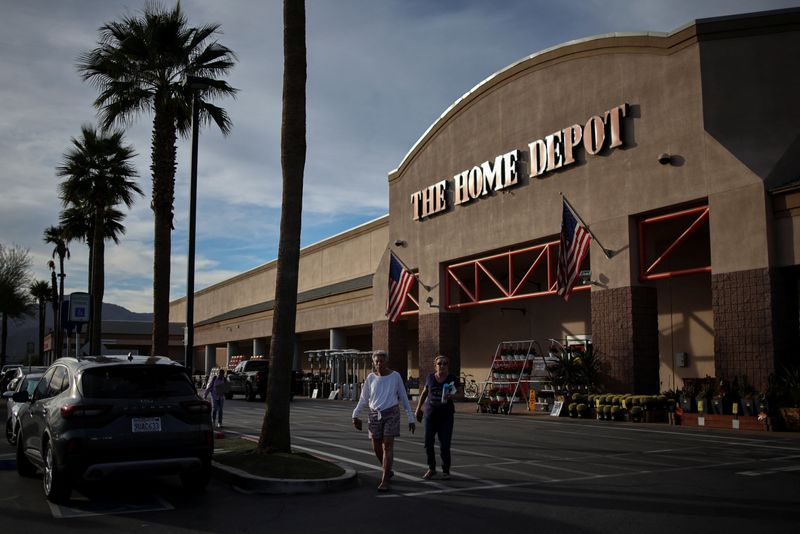 Shoppers walk through the parking lot of a Home Depot where Immigration and Customs Enforcement (ICE) conducted a federal immigration operation earlier in Indio, California, U.S. December 18, 2025. REUTERS/Daniel Cole