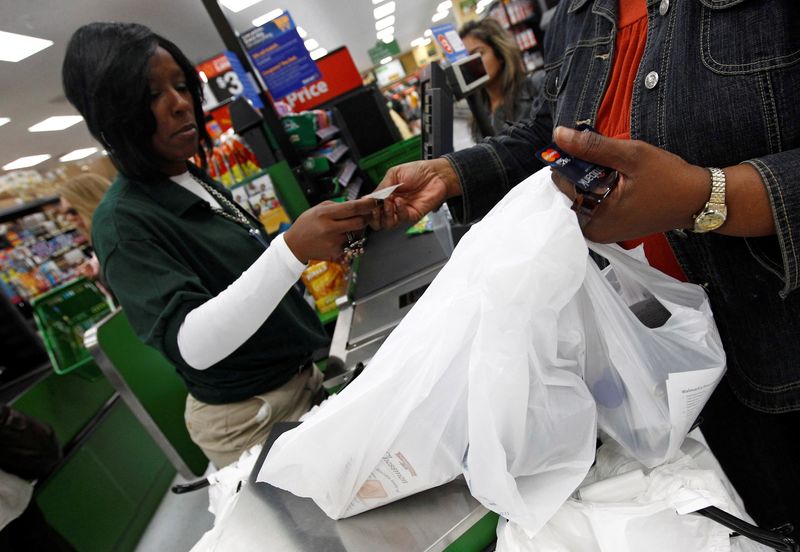 FILE PHOTO: A shopper pays for her purchases in a Walmart Neighborhood Market in Chicago, September 21, 2011. REUTERS/Jim Young/File Photo