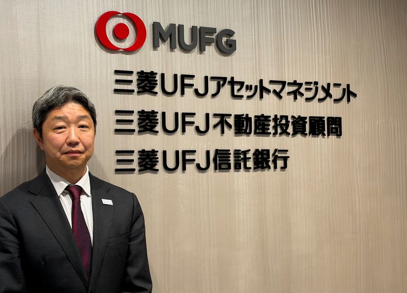 Mitsubishi UFJ Trust and Banking Corporation Executive Officer Satoshi Someya poses in front of the company's logo at its Tokyo office, Japan, January 16, 2026. REUTERS/Miho Uranaka