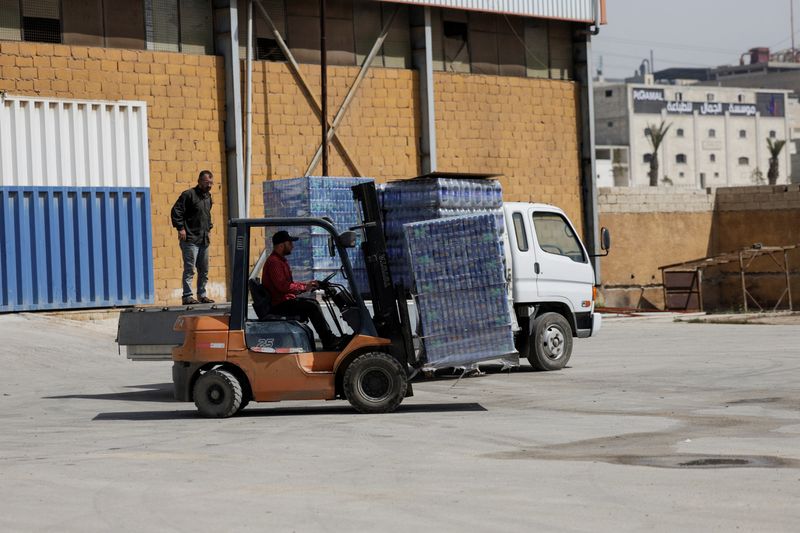 FILE PHOTO: A Toyota forklift operator moves cans of cold drinks at a warehouse in Sarmada, Idlib, Syria March 17, 2025. REUTERS/Khalil Ashawi/File Photo