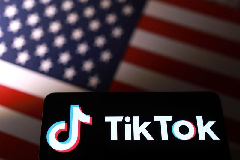 TikTok logo is placed on a U.S. flag in this illustration taken September 24, 2025. REUTERS/Dado Ruvic/Illustration