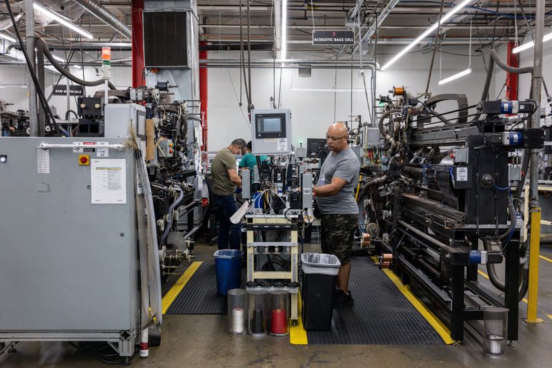Workers operate machinery at D'Addario's instrument strings production facility in Farmingdale, New York, U.S., July 10, 2025. REUTERS/Kylie Cooper/File Photo