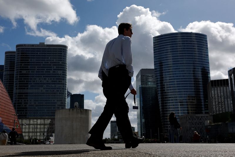 People walk past the skyscrapers of the financial and business district of La Defense in Puteaux near Paris, france, September 12, 2025. REUTERS/Stephanie Lecocq