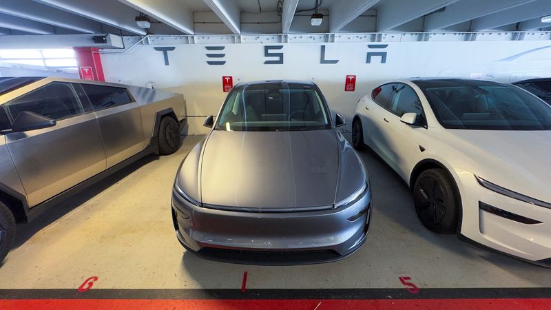Refreshed versions of the Tesla Model Y are shown parked next to a Tesla Cybertruck outside a Tesla store in San Diego, California, U.S. October 21, 2025. REUTERS/Mike Blake