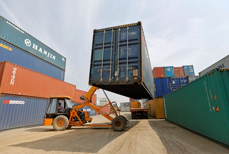 A mobile crane carries a container at Thar Dry Port in Sanand in the western state of Gujarat, India, February 13, 2017. Picture taken February 13, 2017. REUTERS/Amit Dave