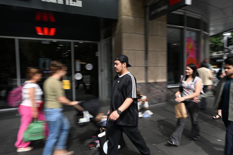 People walk past a bank in Sydney’s central business district, Australia, February 3, 2026. REUTERS/Flavio Brancaleone