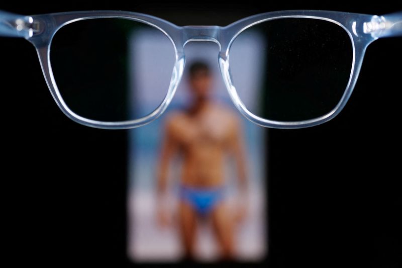 A photorealistic image generated by the artificial intelligence chatbot Grok of a Reuters journalist is shown on a phone’s screen in this illustration picture taken January 22, 2026. The image is one of scores of sexualized or degrading images recently created by Grok in response to reporters' prompts.  REUTERS/Mike Blake