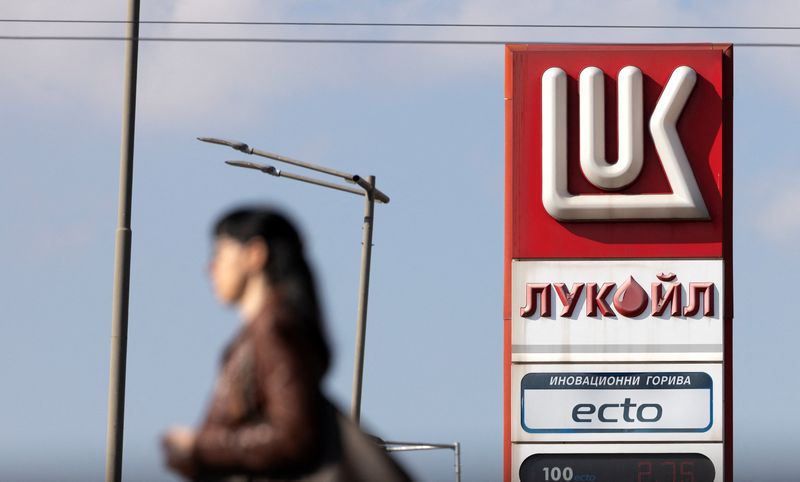 A woman walks near a Lukoil gas station in Sofia, Bulgaria, October 23, 2025.  REUTERS/Stoyan Nenov