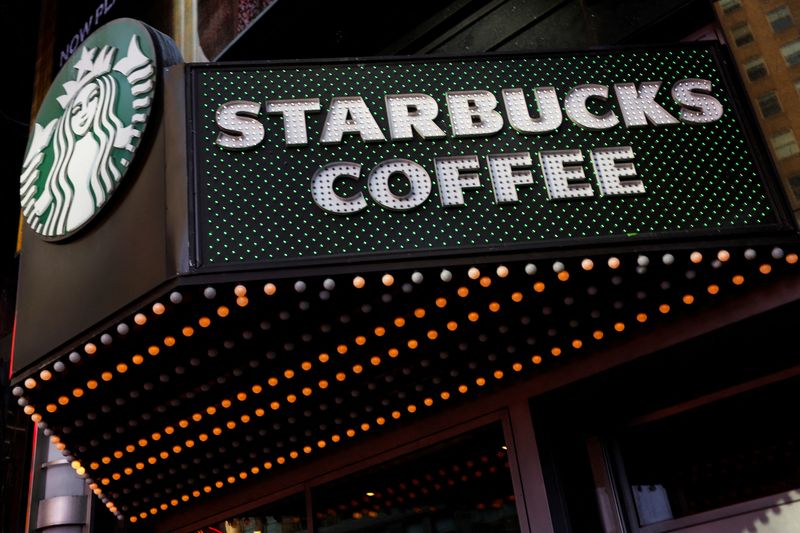 FILE PHOTO: A Starbucks store entrance sign is seen at Times Square in New York City, U.S., February 25, 2025. REUTERS/Shannon Stapleton/File Photo