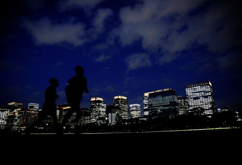 FILE PHOTO: People run with Tokyo's business district in the background, in Tokyo, Japan, April 7, 2021. REUTERS/Kim Kyung-Hoon/File Photo