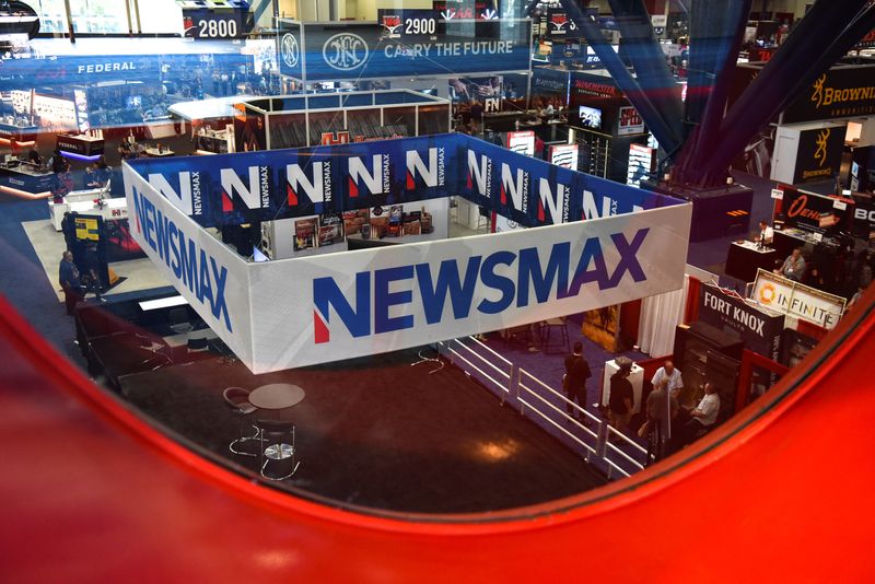 A Newsmax booth broadcasts as attendees try out the guns on display at the National Rifle Association (NRA) annual convention in Houston, Texas, U.S. May 29, 2022. REUTERS/Callaghan O'Hare