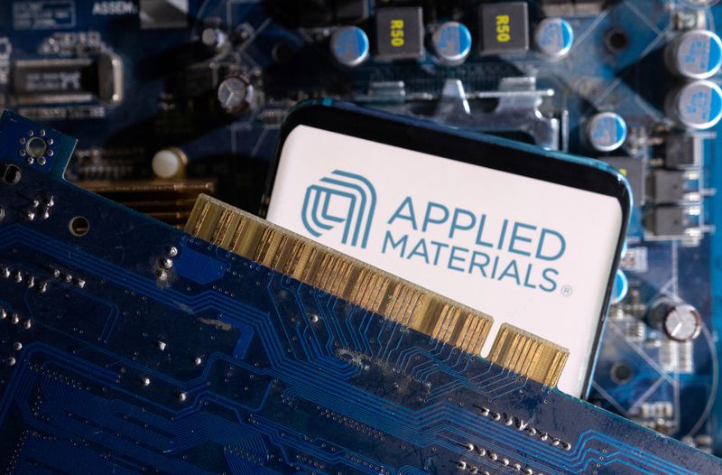 A smartphone with a displayed Applied Materials logo is placed on a computer motherboard in this illustration taken March 6, 2023. REUTERS/Dado Ruvic/Illustration