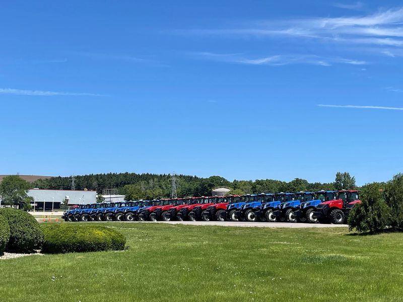 Red and blue tractors line up in celebration of the July 4th independence holiday in front of CNH Industrial's plant in Sturtevant, Wisconsin, U.S., June 27, 2024. REUTERS/Timothy Aeppel