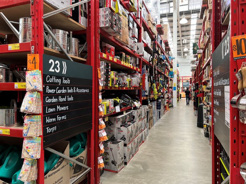 An employee of Bunnings, which is part of the Wesfarmers retail conglomerate, walks down an aisle at a store in Sydney, Australia February 17, 2022. REUTERS/Stephen Coates