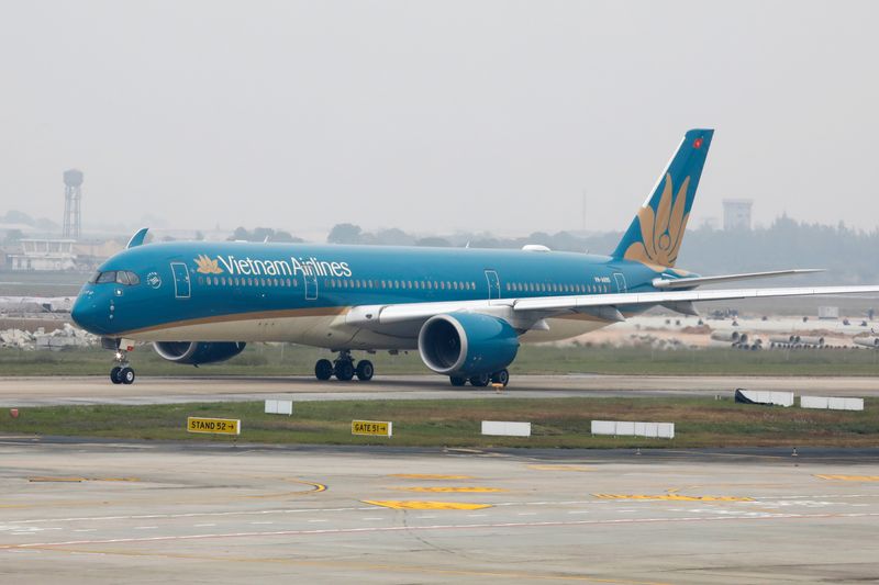 FILE PHOTO: An aircraft of the national flag carrier Vietnam Airlines taxis at Noi Bai airport in Hanoi, Vietnam December 23, 2020. Picture taken December 23, 2020. REUTERS/Kham/ File Photo