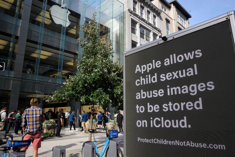 FILE PHOTO: A truck from the child advocacy organization Heat Initiative calling on Apple to do more to police child sex abuse material on iCloud, is parked outside the Apple store as people line up to get the new iPhone 15 in Boston, Massachusetts, U.S., September 22, 2023. REUTERS/Brian Snyder/File Photo