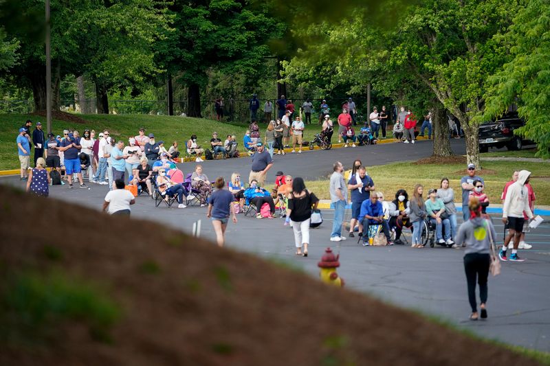 People line up outside a Kentucky Career Center hoping to find assistance with their unemployment claim in Frankfort, Kentucky, U.S. June 18, 2020. REUTERS/Bryan Woolston