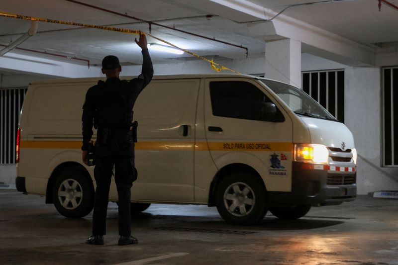 A member of the Panamanian police holds up a police cordon as a truck loaded with boxes leaves following a search by investigative police at offices tied to a unit of Hong Kong conglomerate CK Hutchison, in an underground parking area in the upscale Albrook district of Panama City, Panama, February 26, 2026. REUTERS/Aris Martinez