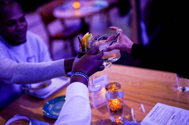 FILE PHOTO: Diners cheer with their drinks at The Point D.C., an American & fusion seafood restaurant located at the junction of the Potomac and Anacostia Rivers, in Washington, D.C., U.S., November 6, 2025. REUTERS/Al Drago/File Photo