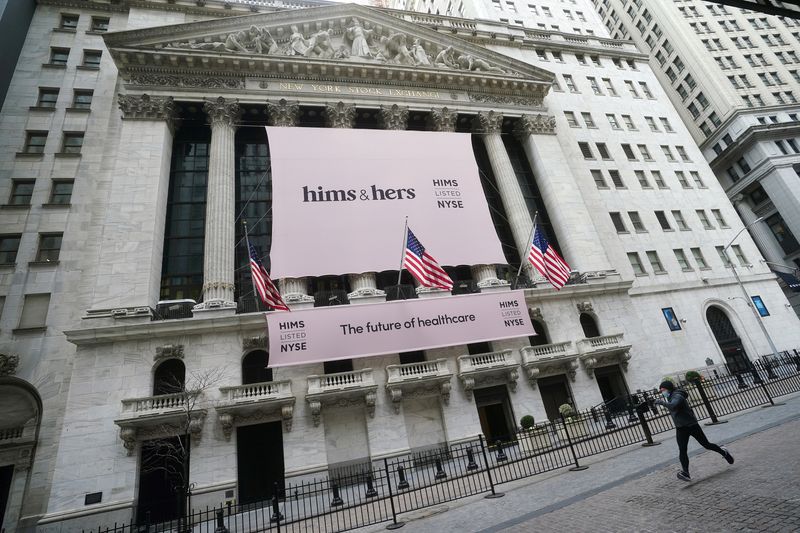 The New York Stock Exchange with a Hims & Hers Health, Inc banner is pictured as a person runs past in the Manhattan borough of New York City, New York, U.S., January  21, 2021. REUTERS/Carlo Allegri
