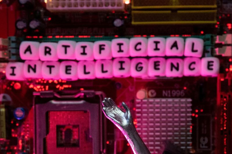 FILE PHOTO: AI (Artificial Intelligence) letters and robot hand are placed on computer motherboard in this illustration taken, June 23, 2023. REUTERS/Dado Ruvic/Illustration/File Photo