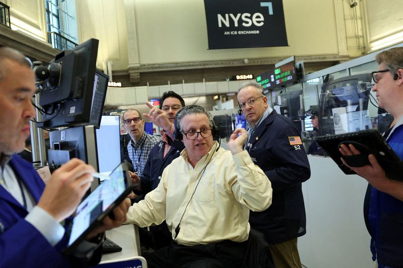 FILE PHOTO: Futures-options traders work on the floor at the New York Stock Exchange's NYSE American (AMEX) in New York City, U.S., March 2, 2026.  REUTERS/Brendan McDermid/File Photo