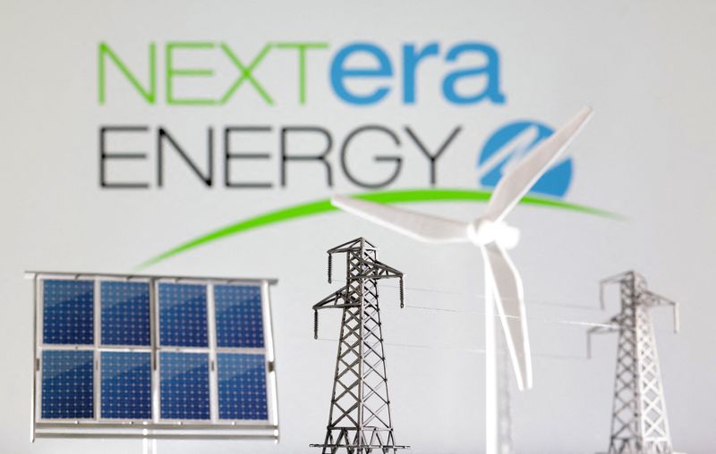FILE PHOTO: Miniatures of windmill, solar panel and electric pole are seen in front of NextEra Energy logo in this illustration taken January 17, 2023. REUTERS/Dado Ruvic/Illustration/File Photo