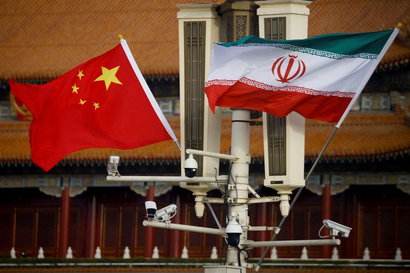 The national flags of China and Iran fly in Tiananmen Square, Beijing, China, February 14, 2023. REUTERS/Thomas Peter/File Photo