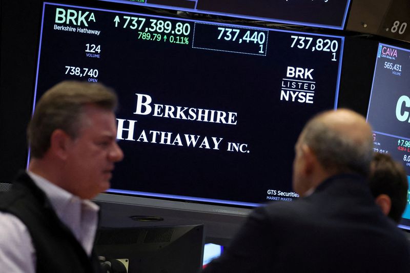 FILE PHOTO: A screen displays the trading information for Berkshire Hathaway inc. as traders work on the floor at the New York Stock Exchange (NYSE) in New York City, U.S., October 22, 2025.  REUTERS/Brendan McDermid/File Photo