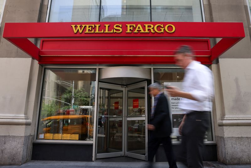 People walk by a Wells Fargo bank branch in New York City, U.S., June 4, 2025. REUTERS/Kylie Cooper