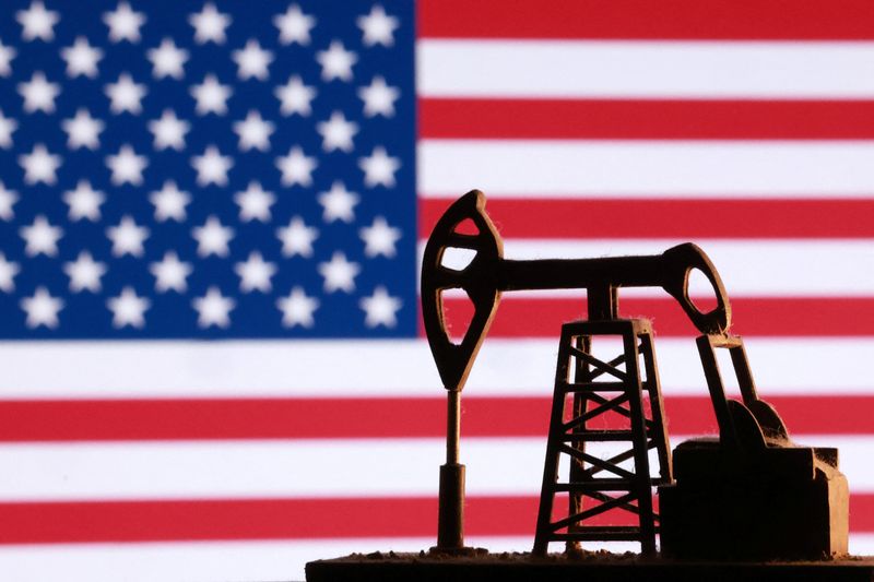 A model of an oil pump is seen in front of a U.S. flag in this illustration taken January 9, 2026. REUTERS/Dado Ruvic/Illustration