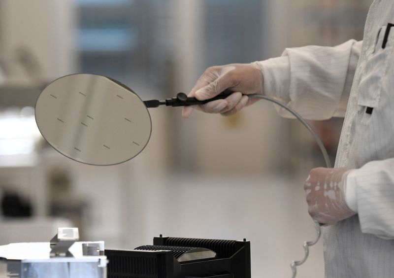 An employee works with a wafer in a production line of Dutch semiconductor company Nexperia, in Hamburg, Germany, June 27, 2024. REUTERS/Fabian Bimmer