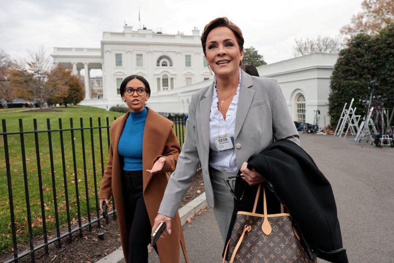 FILE PHOTO: A reporter trails United States Agency for Global Media's (USAGM) Kari Lake as she walks on the driveway outside the West Wing of the White House in Washington, D.C., U.S., November 21, 2025. REUTERS/Jonathan Ernst/File Photo