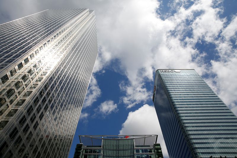 FILE PHOTO: Bank of America building is seen between London's HSBC headquarters and One Canada Square tower in Canary Wharf financial centre, London, Britain June 24, 2016.       REUTERS/Russell Boyce/File Photo