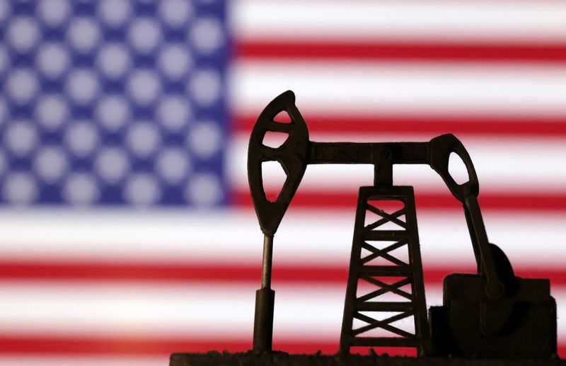 Oil pump jack is seen in front of displayed U.S. flag in this illustration taken, October 8, 2023. REUTERS/Dado Ruvic/Illustration