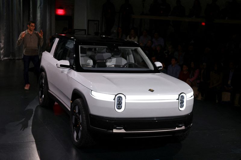 FILE PHOTO: Rivian CEO RJ Scaringe speaks at an event to unveil a smaller R2 SUV in Laguna Beach, California, U.S., March 7, 2024. REUTERS/Mike Blake/File Photo