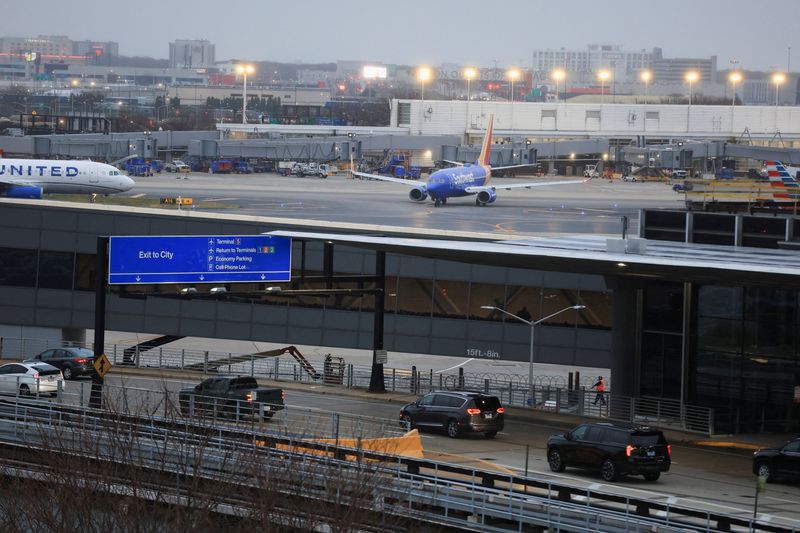 FILE PHOTO: Cars ride at the Chicago O'Hare International Airport in Chicago, Illinois, U.S., November 26, 2025. REUTERS/Jim Vondruska/File Photo