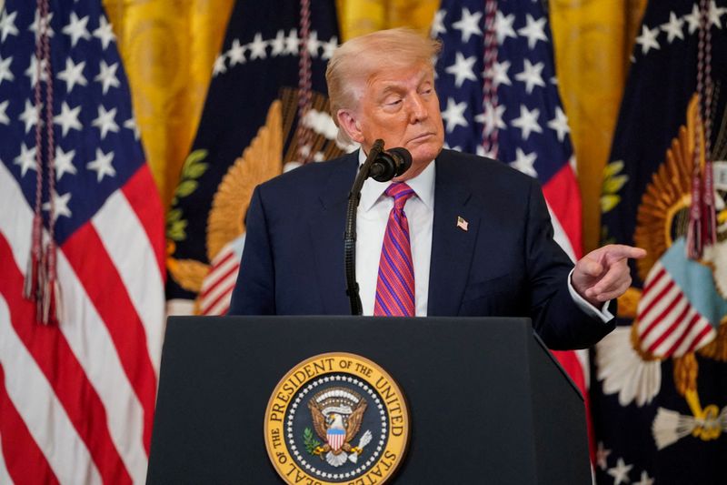 FILE PHOTO: U.S. President Donald Trump speaks before signing the "Genius Act", which will develop regulatory framework for stablecoin cryptocurrencies and expand oversight of the industry, at the White House in Washington, D.C., U.S., July 18, 2025. REUTERS/Nathan Howard/File Photo