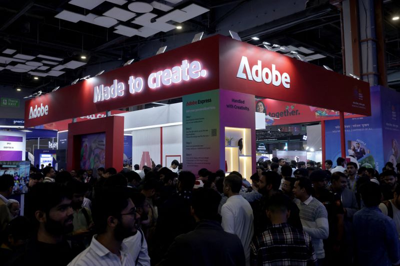 Visitors gather near a stall of Adobe at Bharat Mandapam, one of the venues for AI Impact Summit, in New Delhi, India, February 17, 2026. REUTERS/Bhawika Chhabra