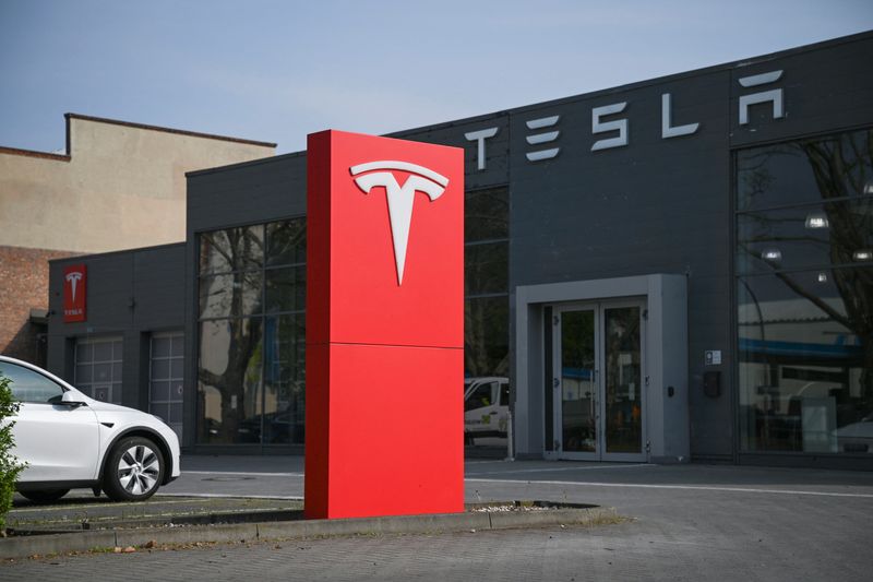 A Tesla logo is pictured at a Tesla dealership in Berlin, Germany April 23, 2025. REUTERS/Annegret Hilse